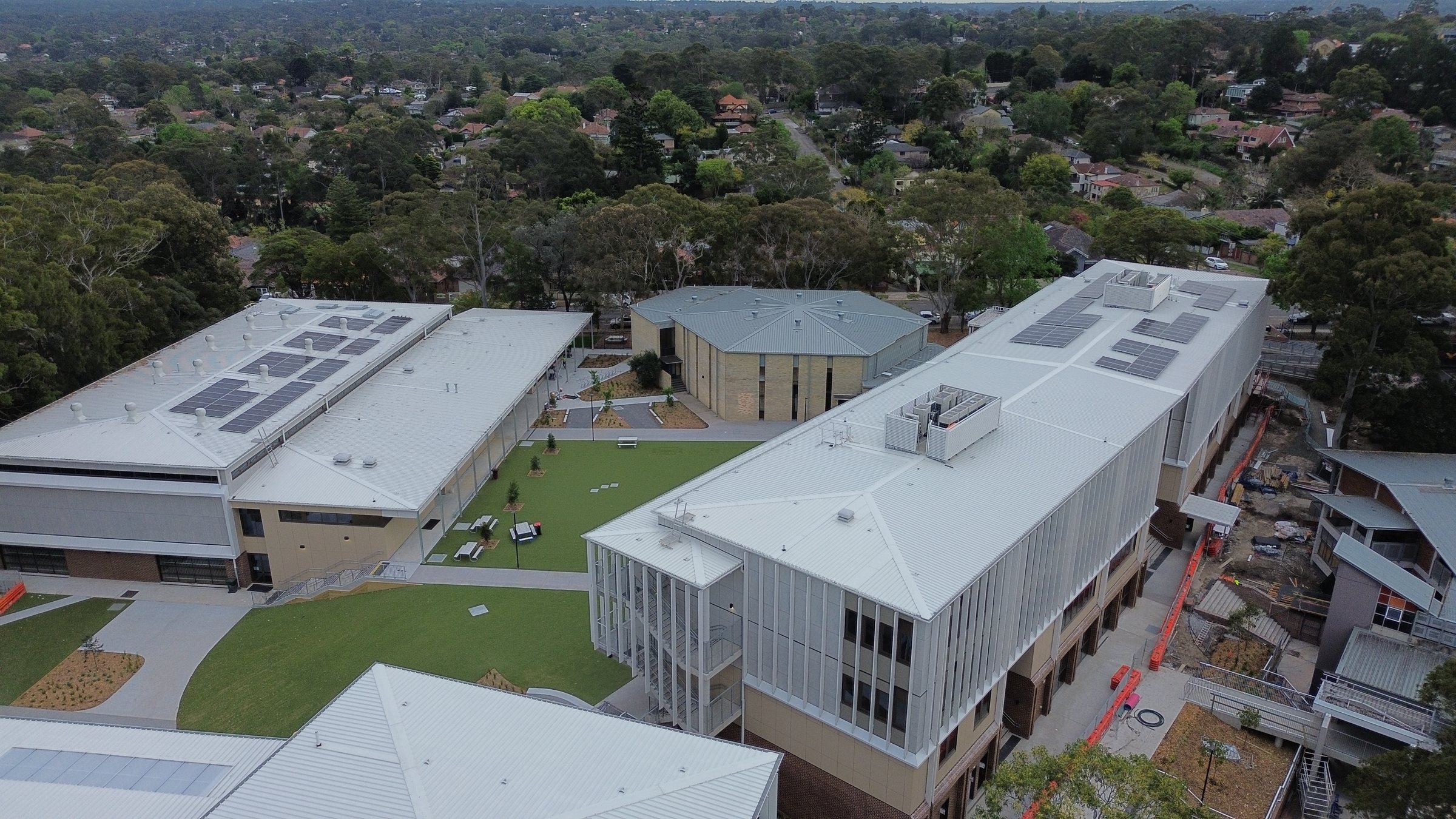 Aerial view of an occupied school campus during roof works